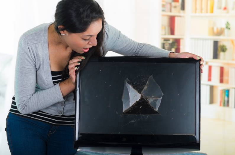 young lady looking at damage monitor